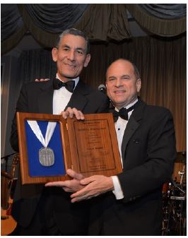 Henry A. Fernandez (right) receives the Calvary medal from Carlos M. Hernandez, Chairman of the Calvary Fund.