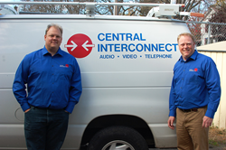 Wade Thompson and Neil Brown pose with one of the vans that Central Interconnect uses to service customers throughout West Michigan.