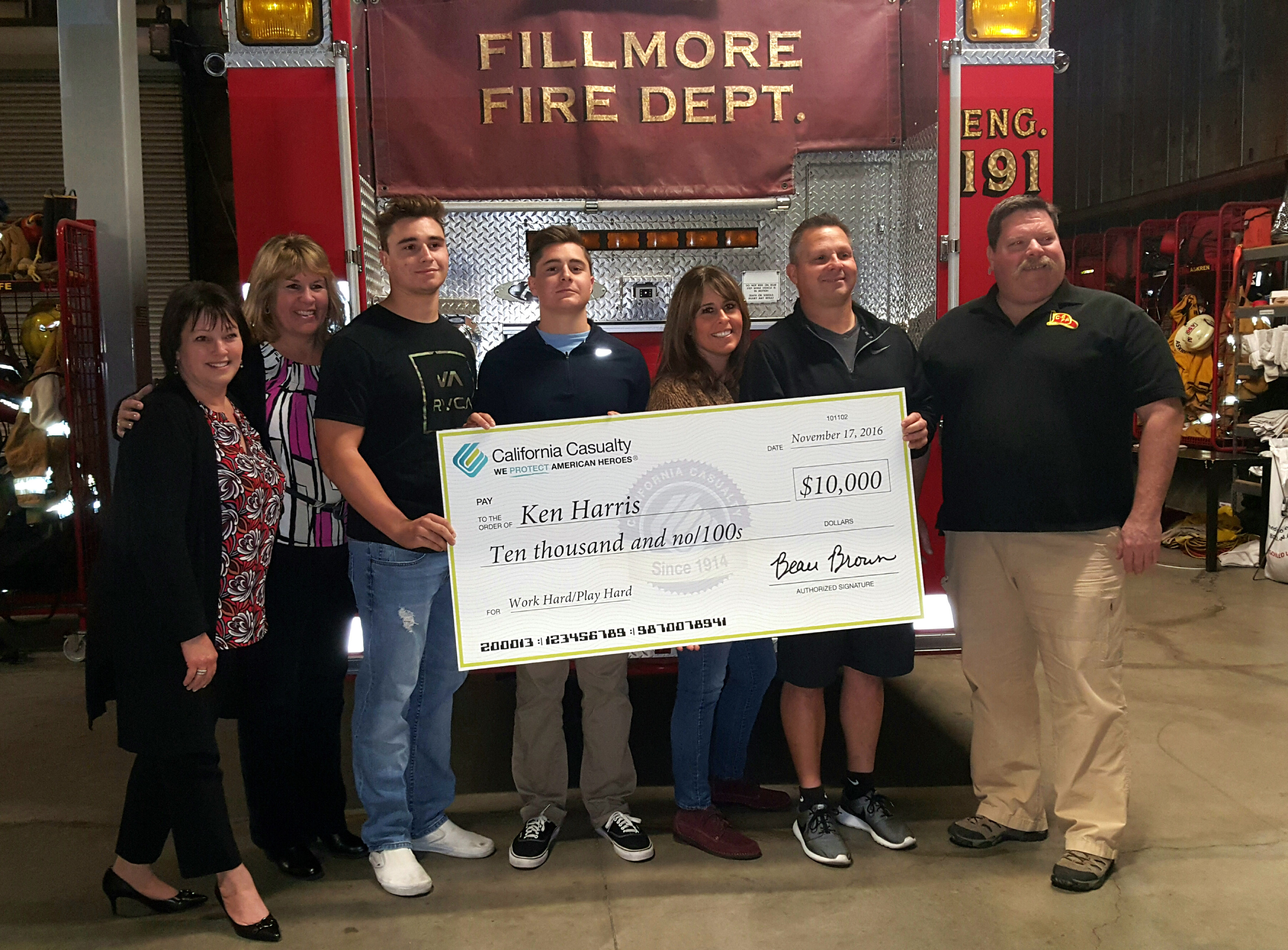 Ken H., second from right, receiving his Work Hard/Play Hard prize from California Casualty