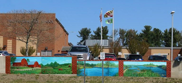 Tracey's Elementary School turned a bland retaining wall into a work of art with painted landscapes on Celtec panels.