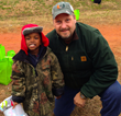Pastor Howard with a young boy who received a coat at a previous event where Winter Survival Kits were distributed.