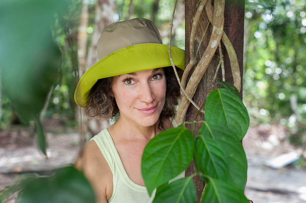 Psychedelic Feminist Zoe Helen on location with ayahuasca vine. Photo by Tracey Eller / Cosmic Sister