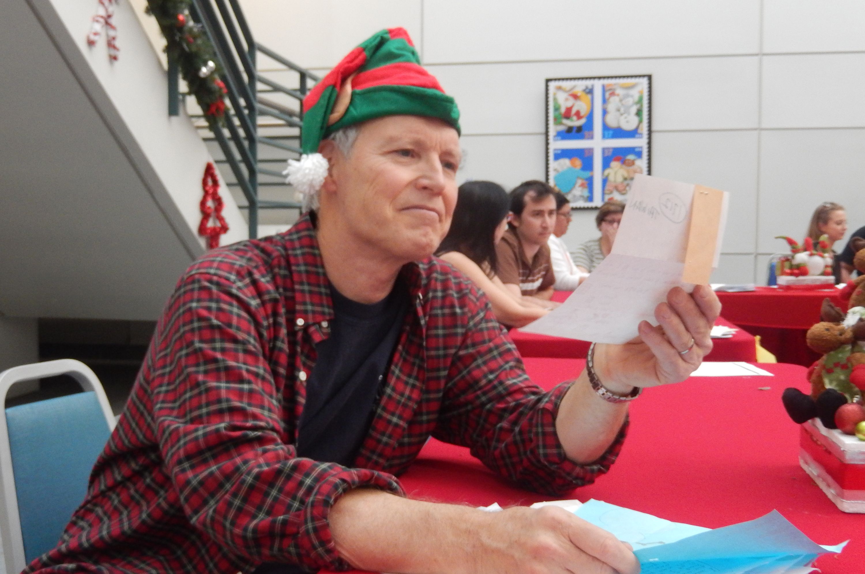 BeAnElf.org's Chief Elf Patrick Reynolds reads a letter to Santa from a child in need