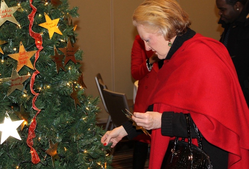 Members of the community place stars purchased in memory or honor of loved ones on HOW’s “Tree of Life” during the annual reception.