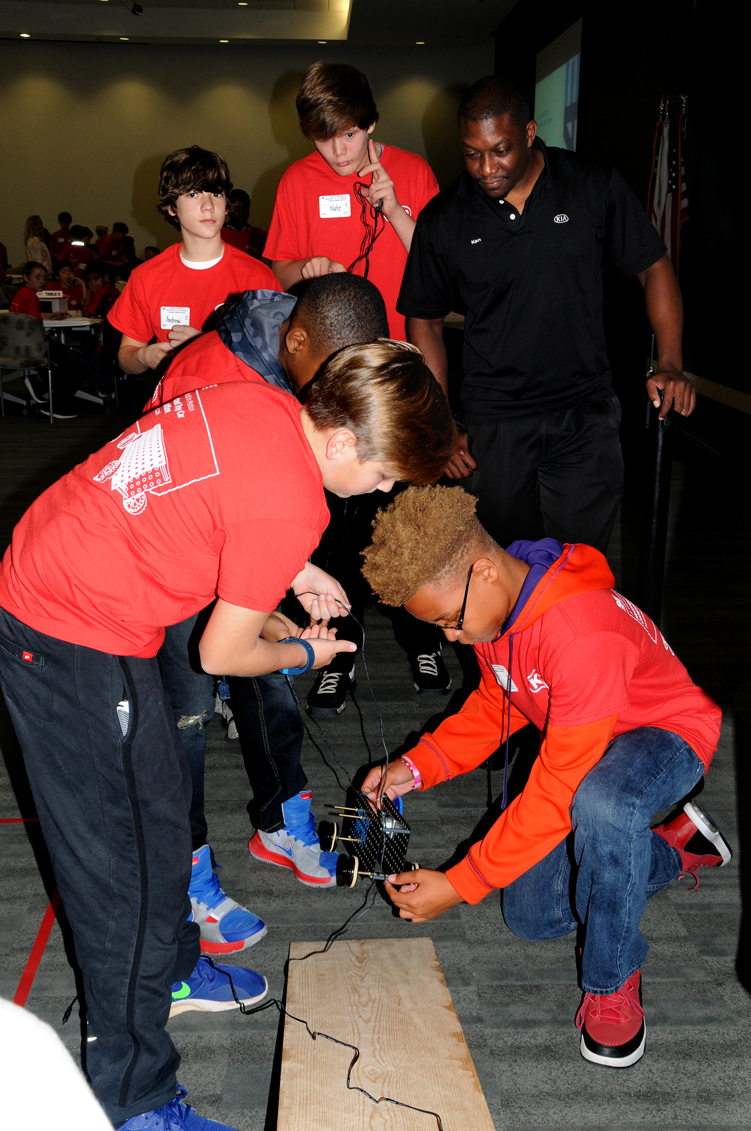 Seventh grade students from Troup County Schools prepare to test their motorized toy car on one of the incline ramps.