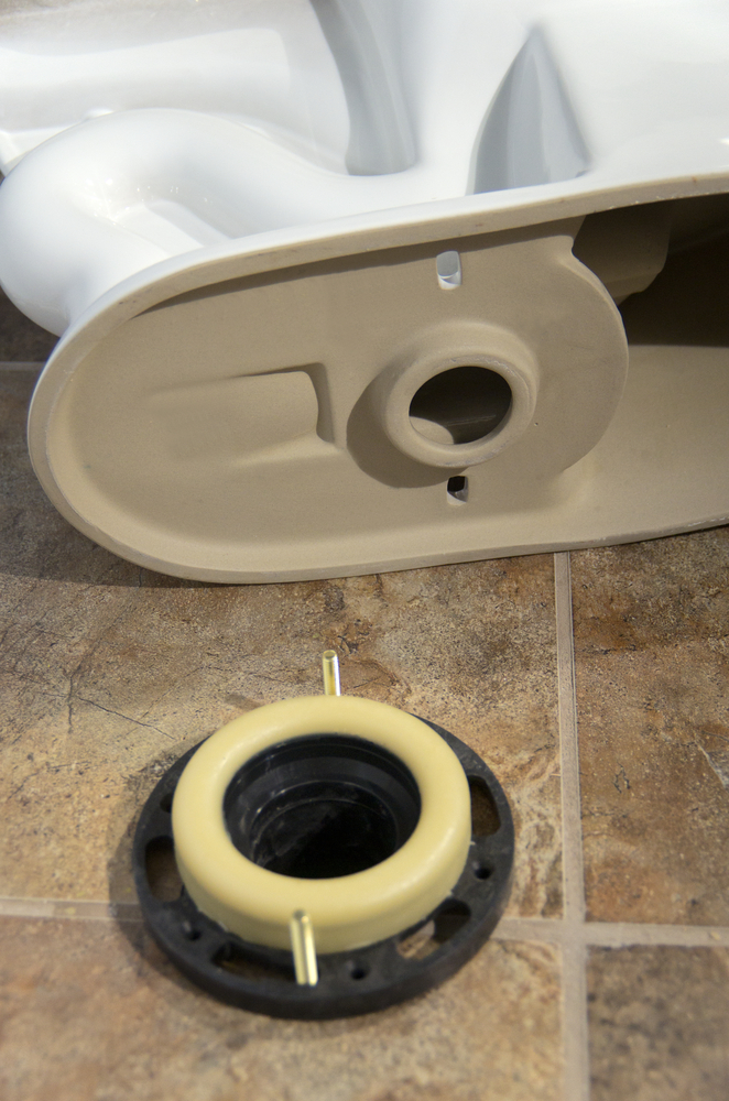 The toilet flange is then screwed into the Toilet Anchor, sandwiching the two together.