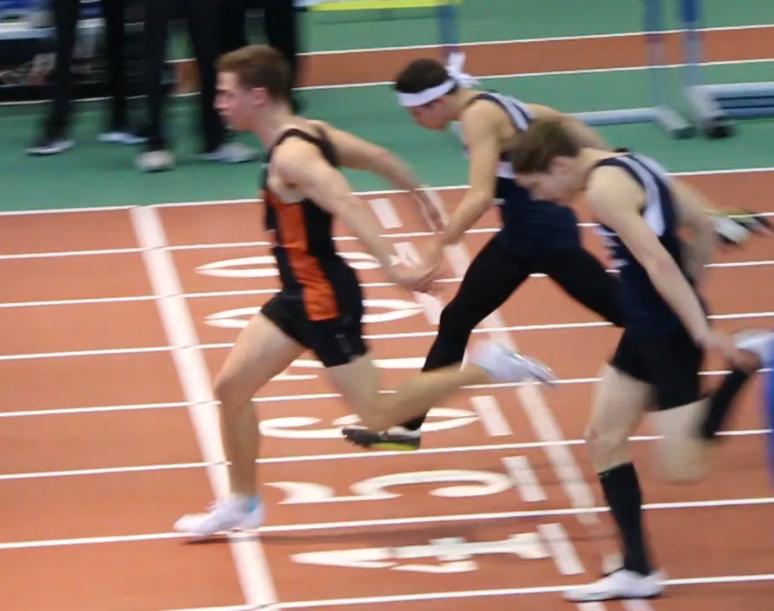 Jackson Thorne (left) blazes across finish line to clinch the league championship in 55-meter dash at the Armory Track & Field Center in New York City.