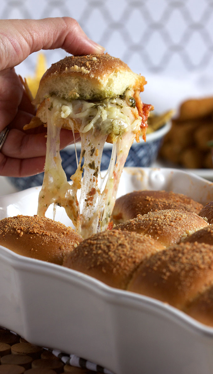 Easy Cheesy Pesto Meatball Sliders are delicious and can feed a crowd in less than 30 minutes. A simple solution for halftime hunger.
