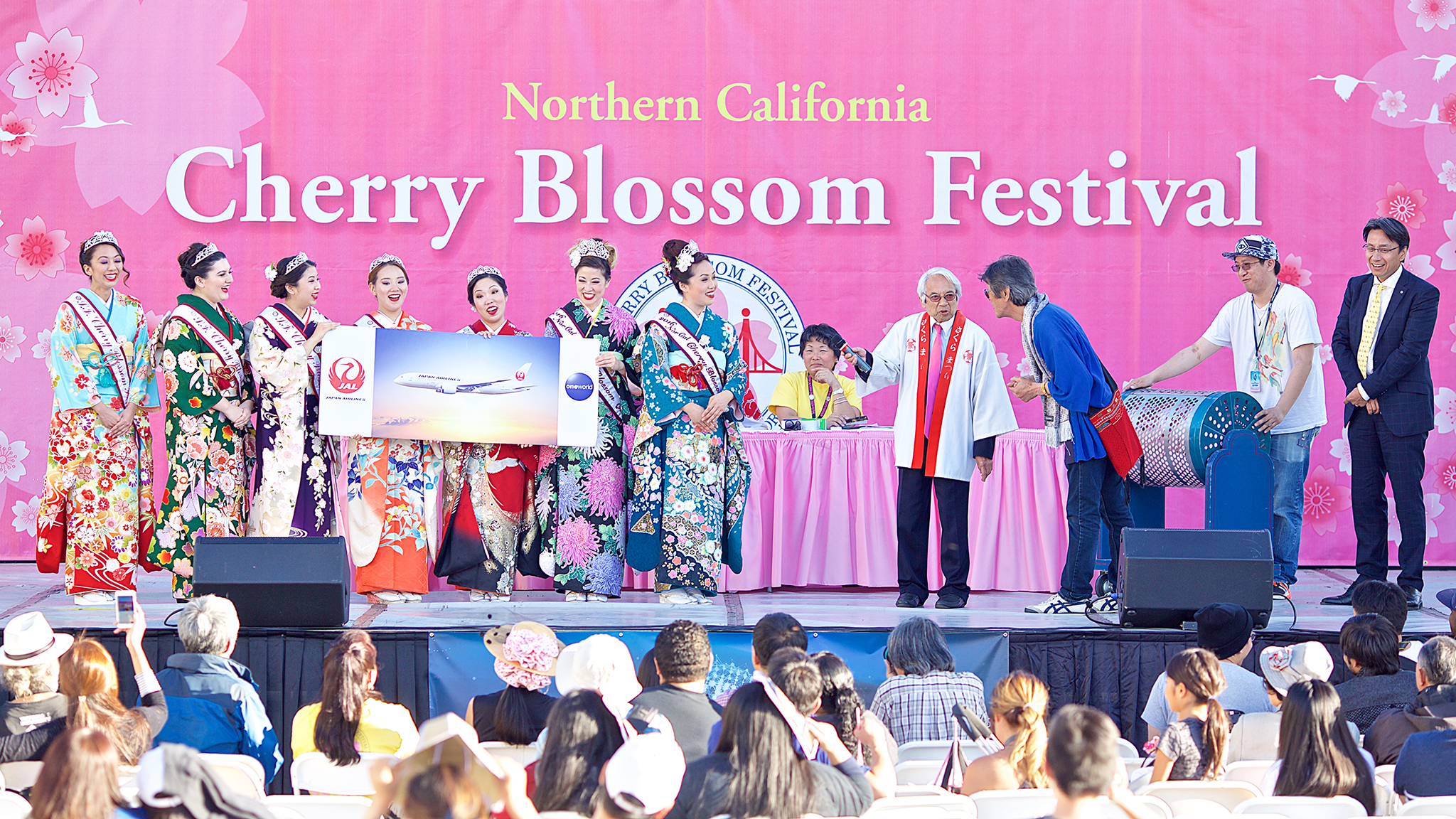 2016 Northern Cherry Blossom Festival queens select one of the grand prize winners of the annual raffle