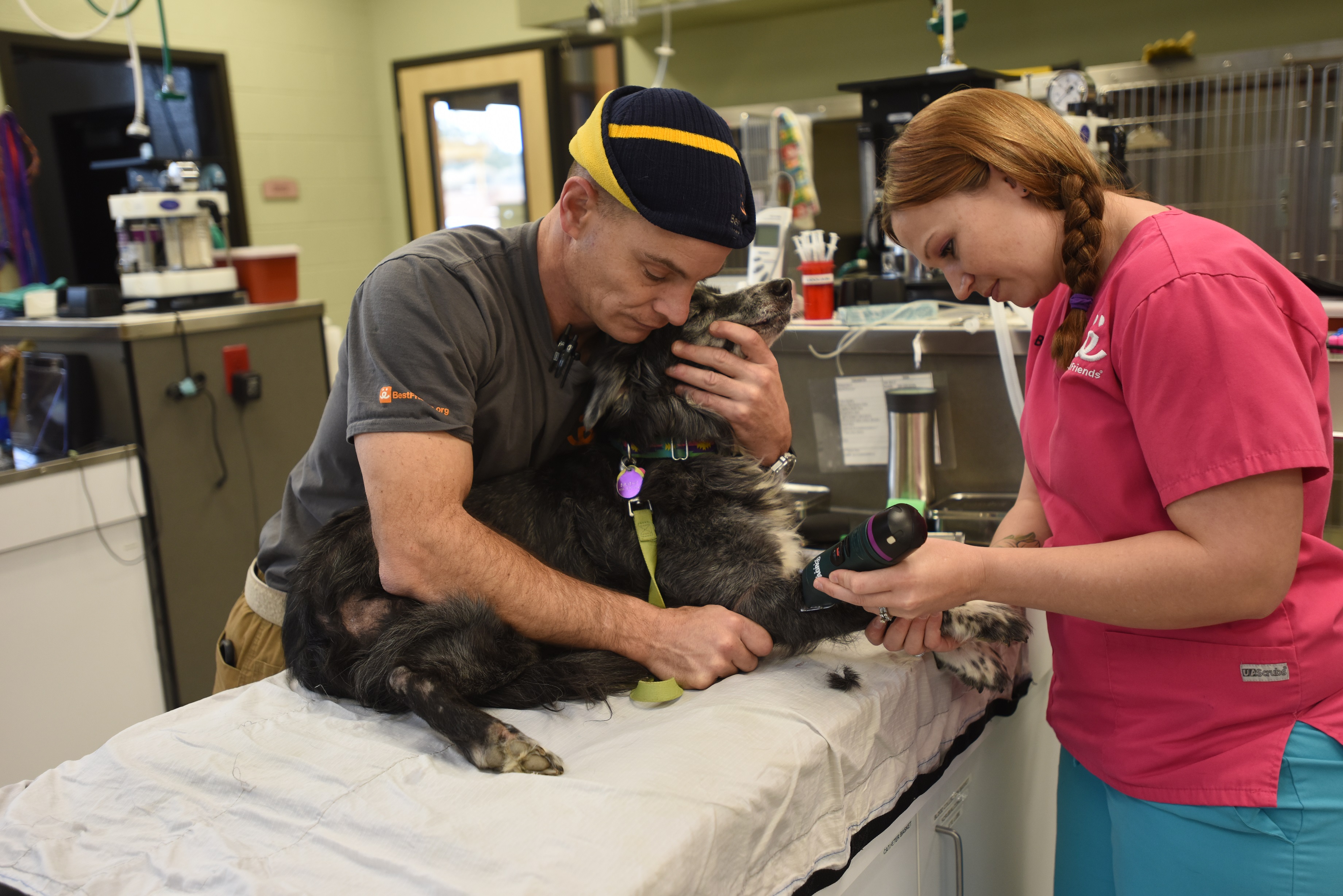 Ethan Gurney and Bonnie Palmer of Best Friends Animal Society prepare Sanctuary dog Mabel for dental procedure.