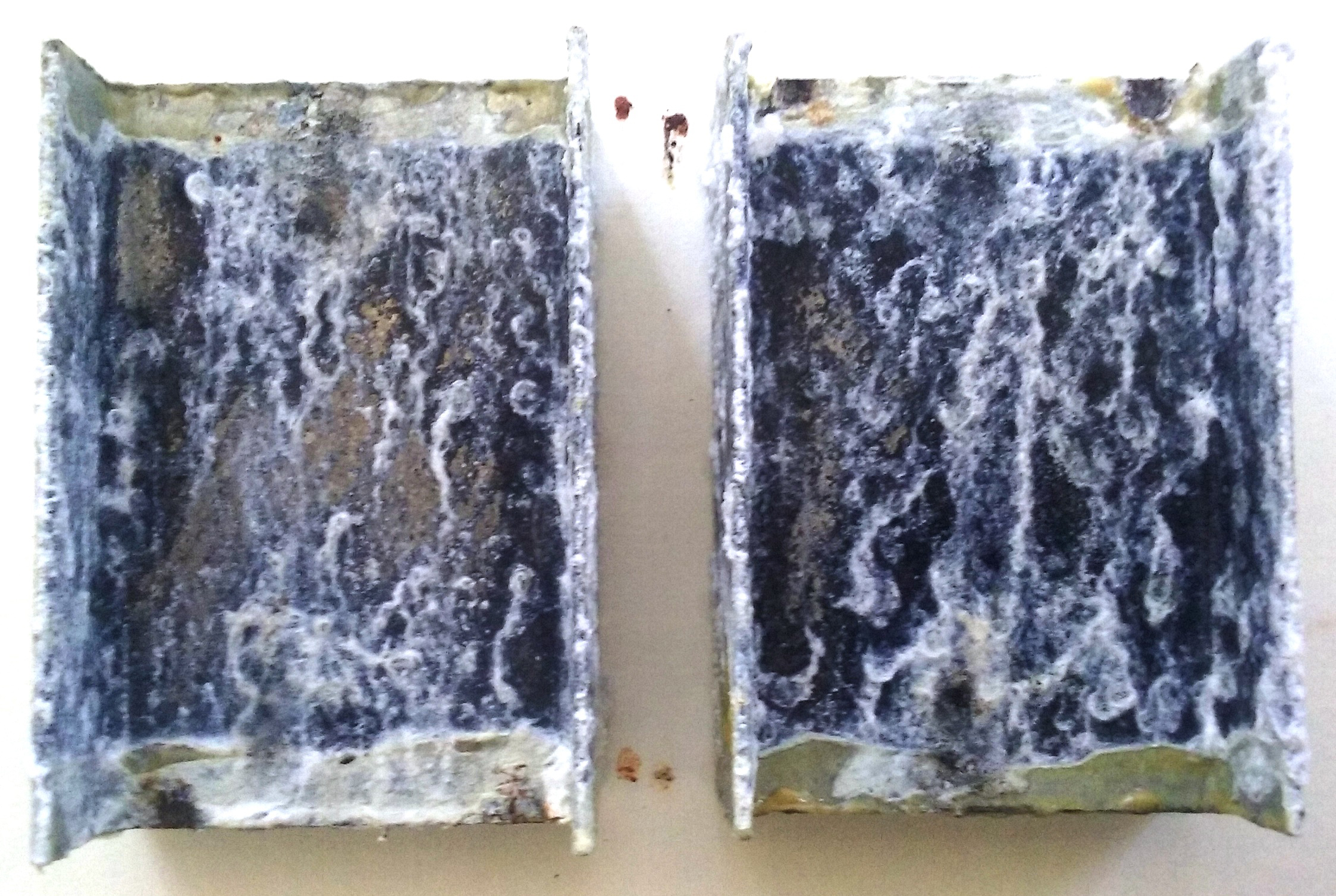The continuous salt spray exposure caused the galvanized sample to begin visibly shedding its protective zinc coating in the form of zinc oxide, also known as white rust.