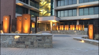 At night, the Farm Bureau pillars created by Studio W are spotlighted by warm LED up lights.