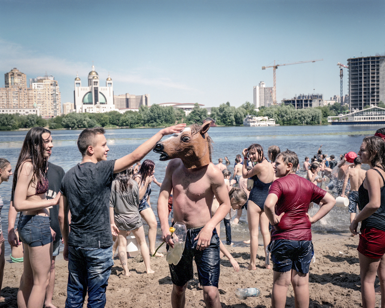 Youth play at Hydropark city beach on Dnieper River. The Kiev metro station connects Hidropark Island to the city and transformed the island to a summer resort for Kievans. © Justyna Mielnikiewicz