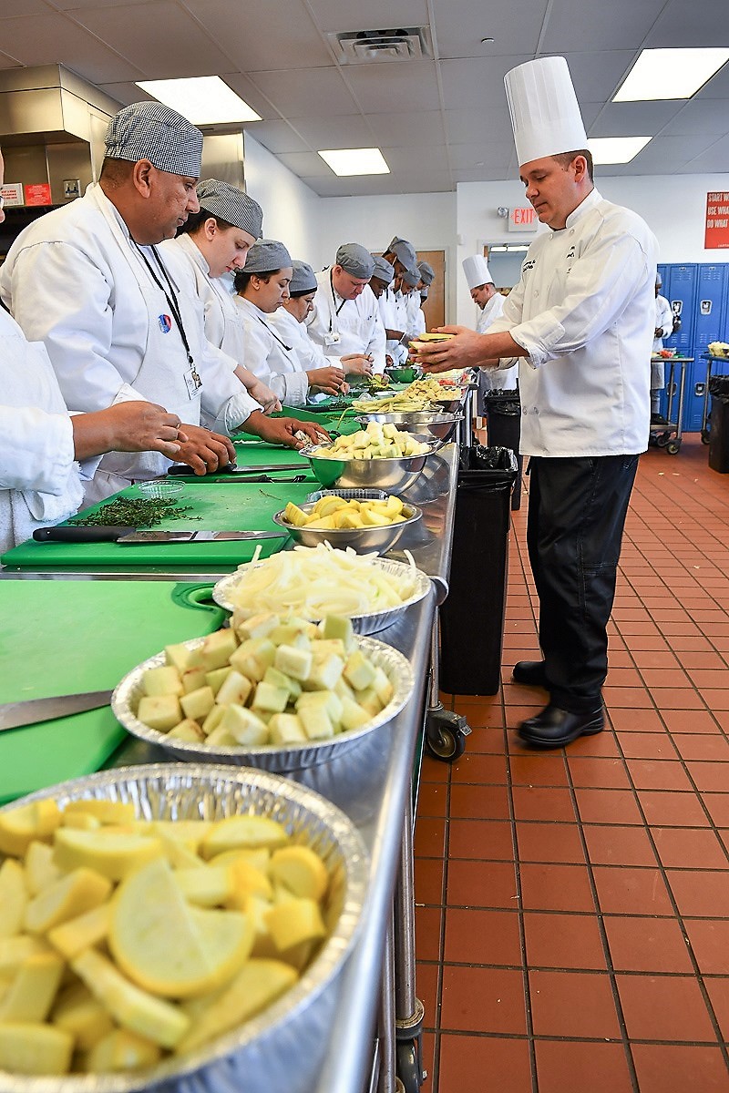 Chef James Cwynar, Director, instructs students the finer points of making ratatouille in the training kitchen of The Culinary School at Eva’s Village, in Paterson, NJ.