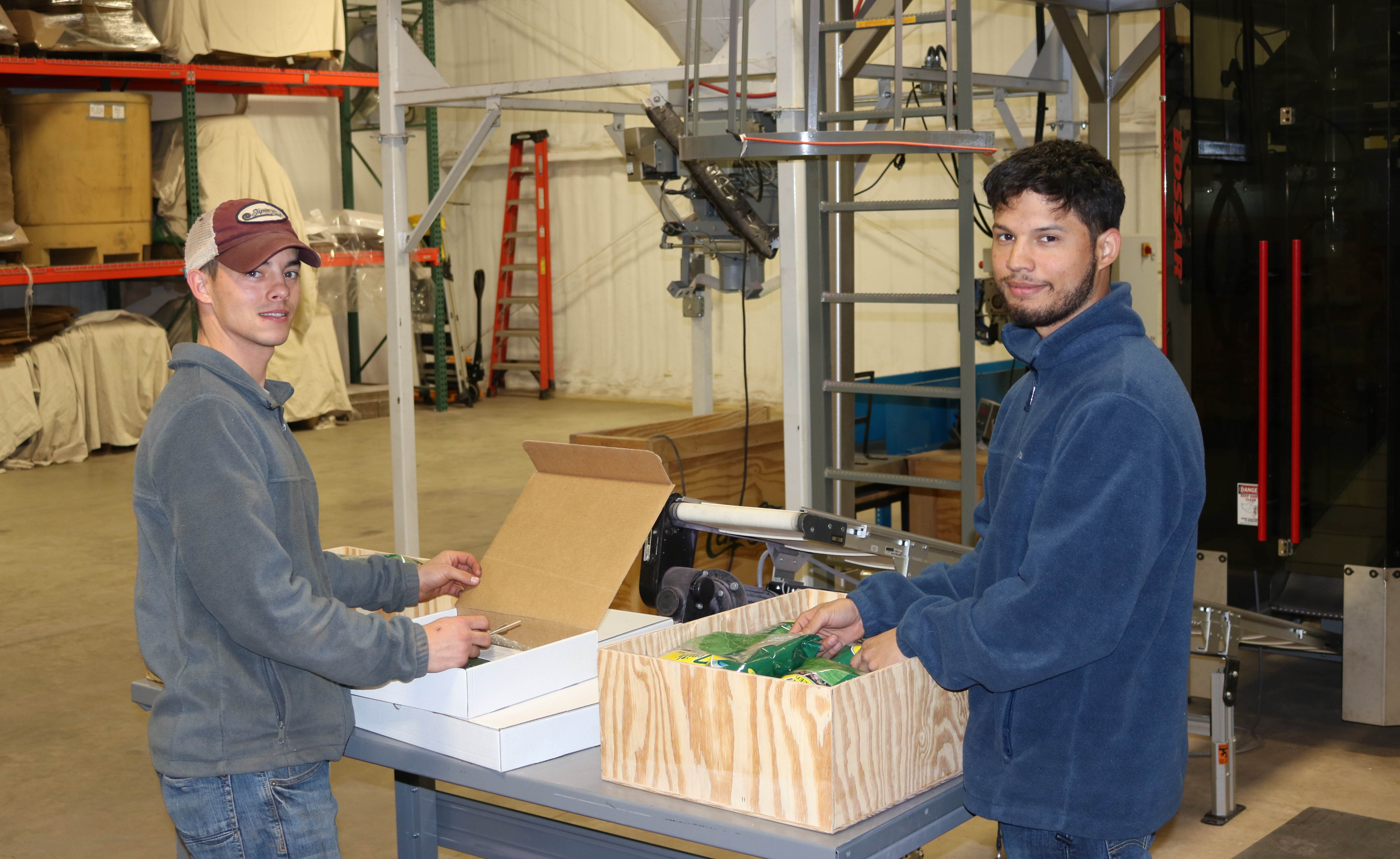 Matt Burnam (left) and Juan Brown fill and ship orders at the Patten Seed distribution center.