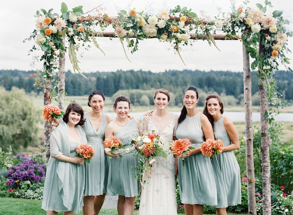 An alder-pole arbor handcrafted from trees foraged from the farm of Whidbey Island florist Tobey Nelson is lavishly decorated with sherbet-toned flowers sourced from local farmers. "I selected the tra