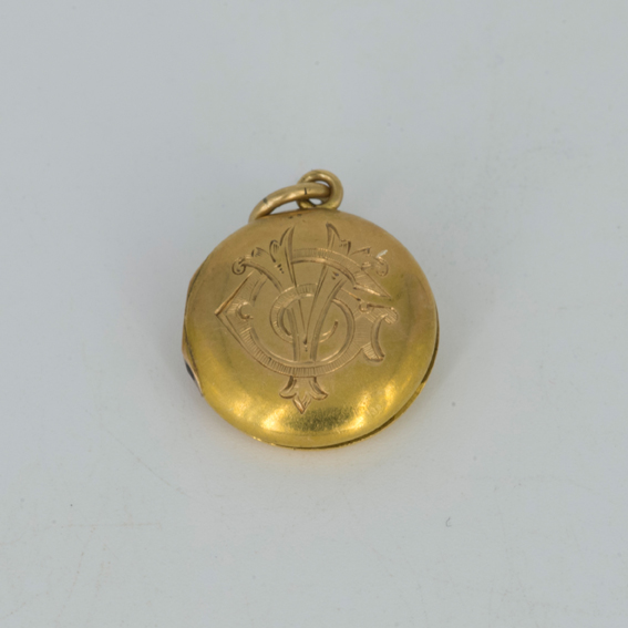 A 18 Carat Gold Locket Engraved with the Initials VC Clark Artifact Display at Titanic The Artifact Exhibition inside Luxor