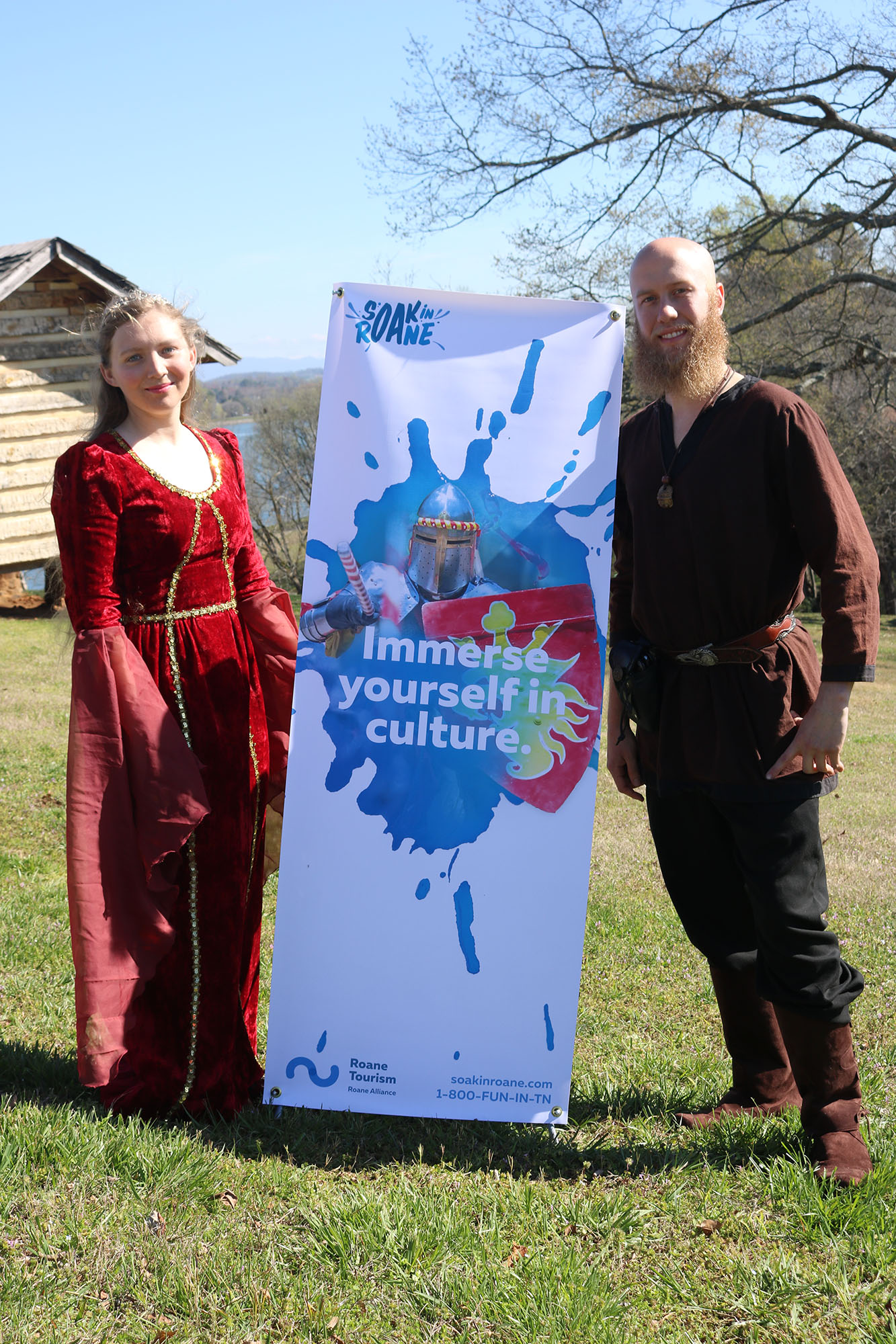 Medieval Faire Actors pose with Soak in Roane campaign signage.