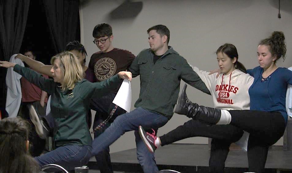 Jeri Misler, managing director of the Gracie Theatre (lower left) leads the ensemble in a kick line as part of the song "Me and My Blanket."