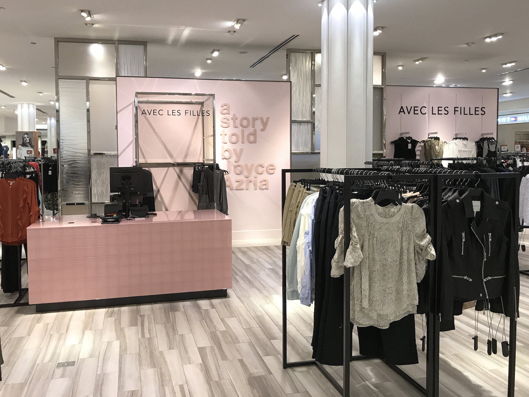 The Macy's Herald Square Avec Les Filles shop features pink walls, tile and smoky glass.