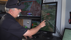 IRIS UAS program director Paige Cutland uses the IRIS UAS airspace situational awareness application to monitor the progress of a drone on a beyond line-of-sight (BVLOS) mission from a portable ground control station set up in a trailer.