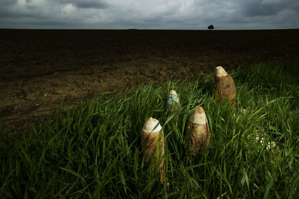 Photograph by Michael St Maur Sheil.  An “iron harvest” of unexploded artillery projectiles found in a farm field on the Somme near the Munich Trench.