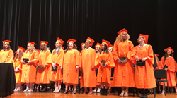 High school students receive diplomas