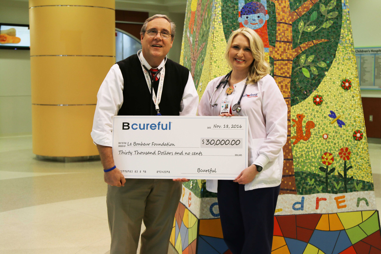 Pictured above, Chief of Pediatric Nephrology and Director of the Tuberous Sclerosis Center of Excellence John Bissler, MD and Ambulatory Care nurse Jayme Wasson accept a $30,000 donation from Bcurefu