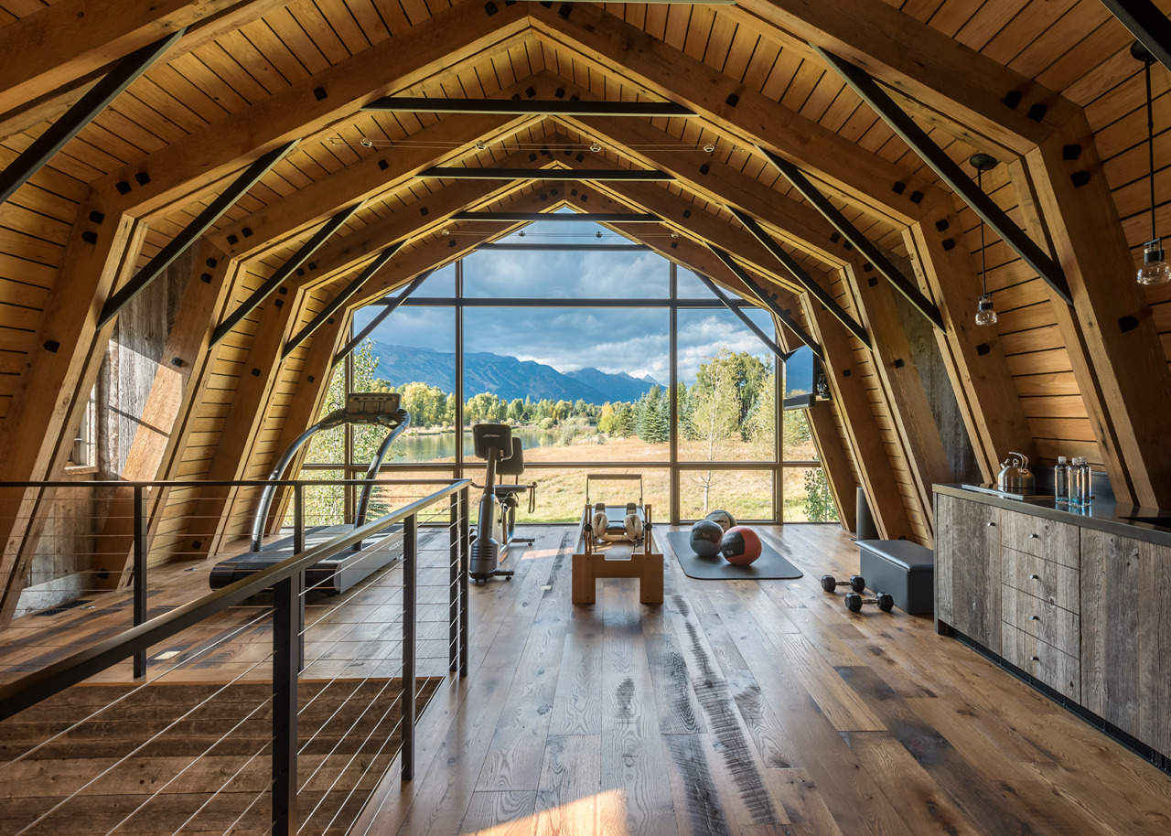 The barn’s “hayloft” open workout area’s floor-to-ceiling windows capture Teton mountain views. A contemporary kitchenette by WRJ Design adds sophisticated convenience (photo by Audrey Hall).