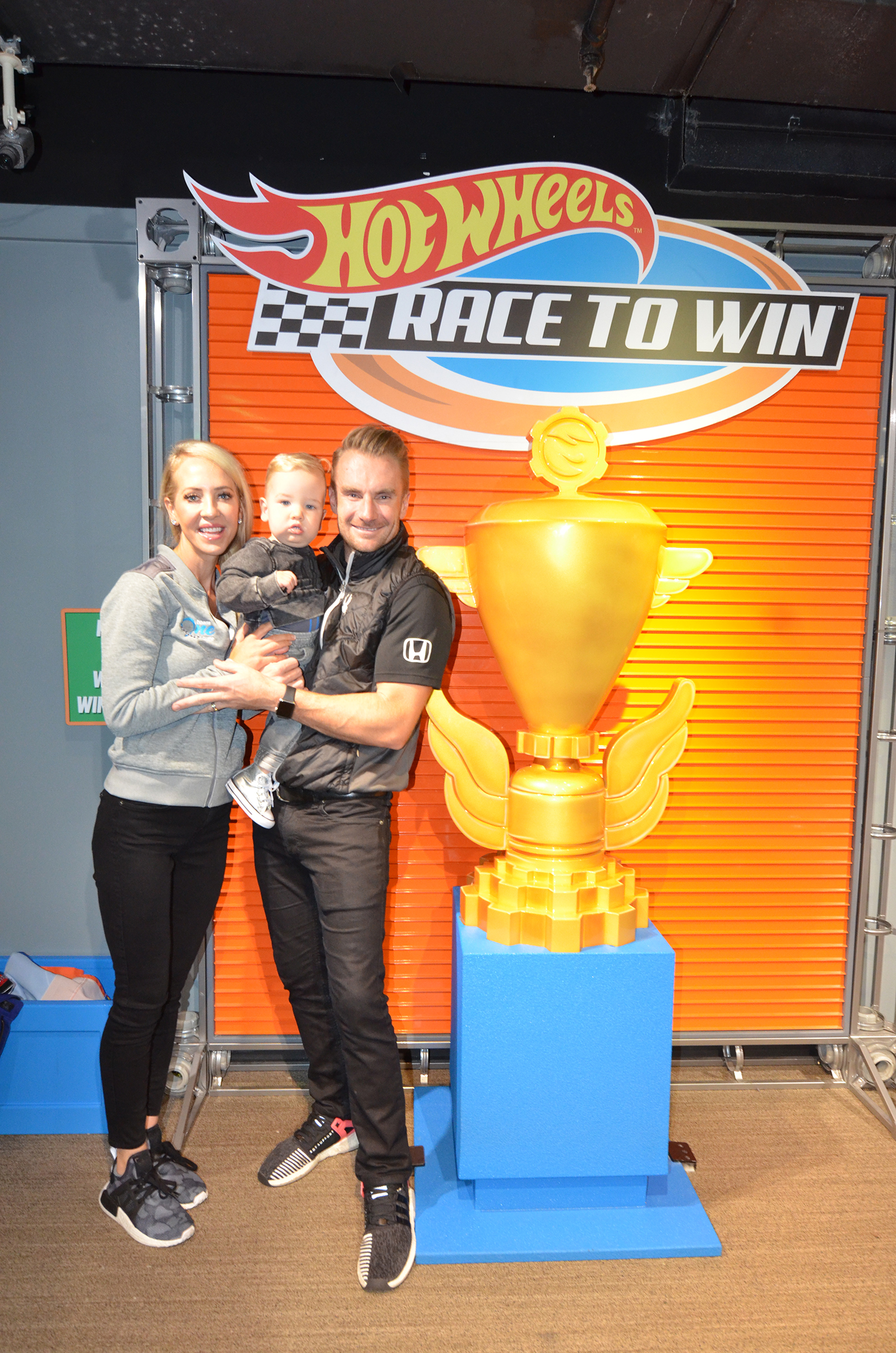 IndyCar driver Jay Howard of Schmidt Peterson Motorsports and family next to the trophy
