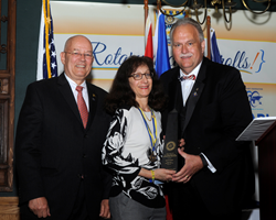 Janis Grover (C), president of Grover Global Food Marketing, receives District 7510 Rotarian of the Year Award from David Breidinger (R), award committee chair, and Michael Townley, district secretary (L).