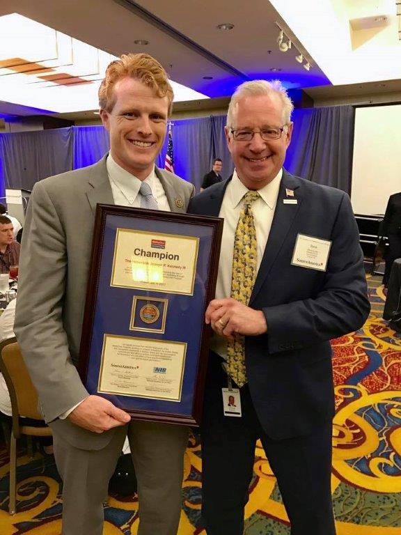 Rep. Joe P. Kennedy III, D-Mass, accepts the award designating him an AbilityOne Congressional Champion from SourceAmerica CEO Steve Soroka.