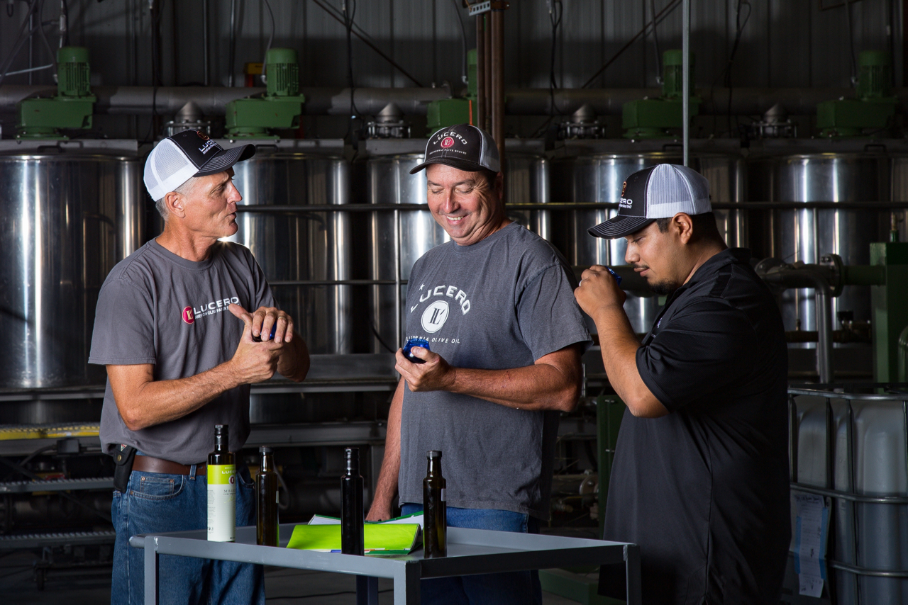 Larry Treat (left) Master Miller, selects new harvest olive oils for competition with his team.