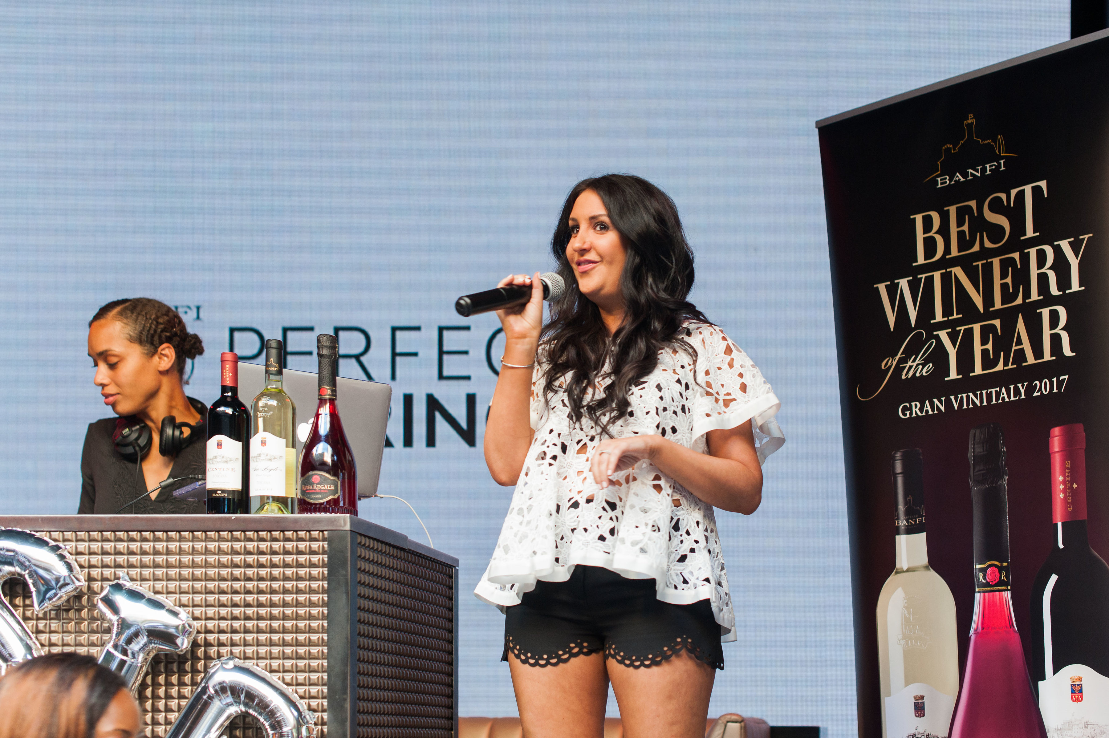 #BanfiSips Perfect Pairing - Host Everything Erica announcing the raffle winners while DJ Evie the Cool is spinning the music