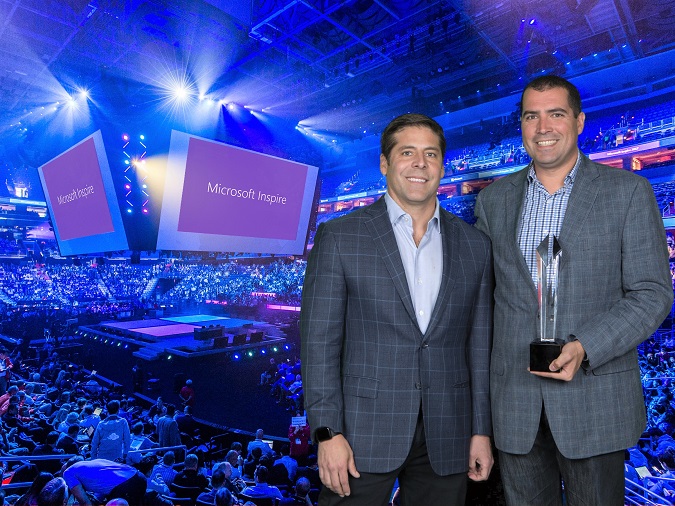 Ron Huddleston, corporate vice president, One Commercial Partner, Microsoft Corp with Christian Morin and the Inspire Award for Canadian Partner of the Year