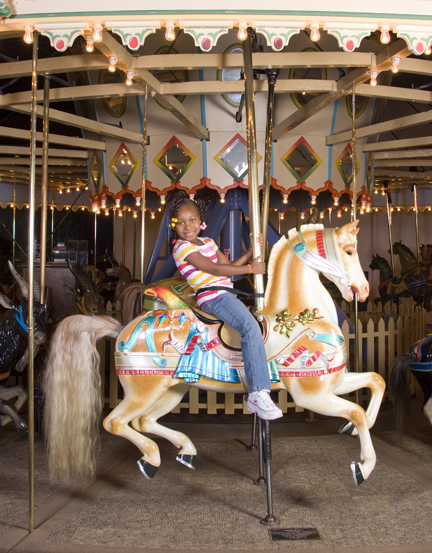 A girl and her horse on the 100-year-old carousel