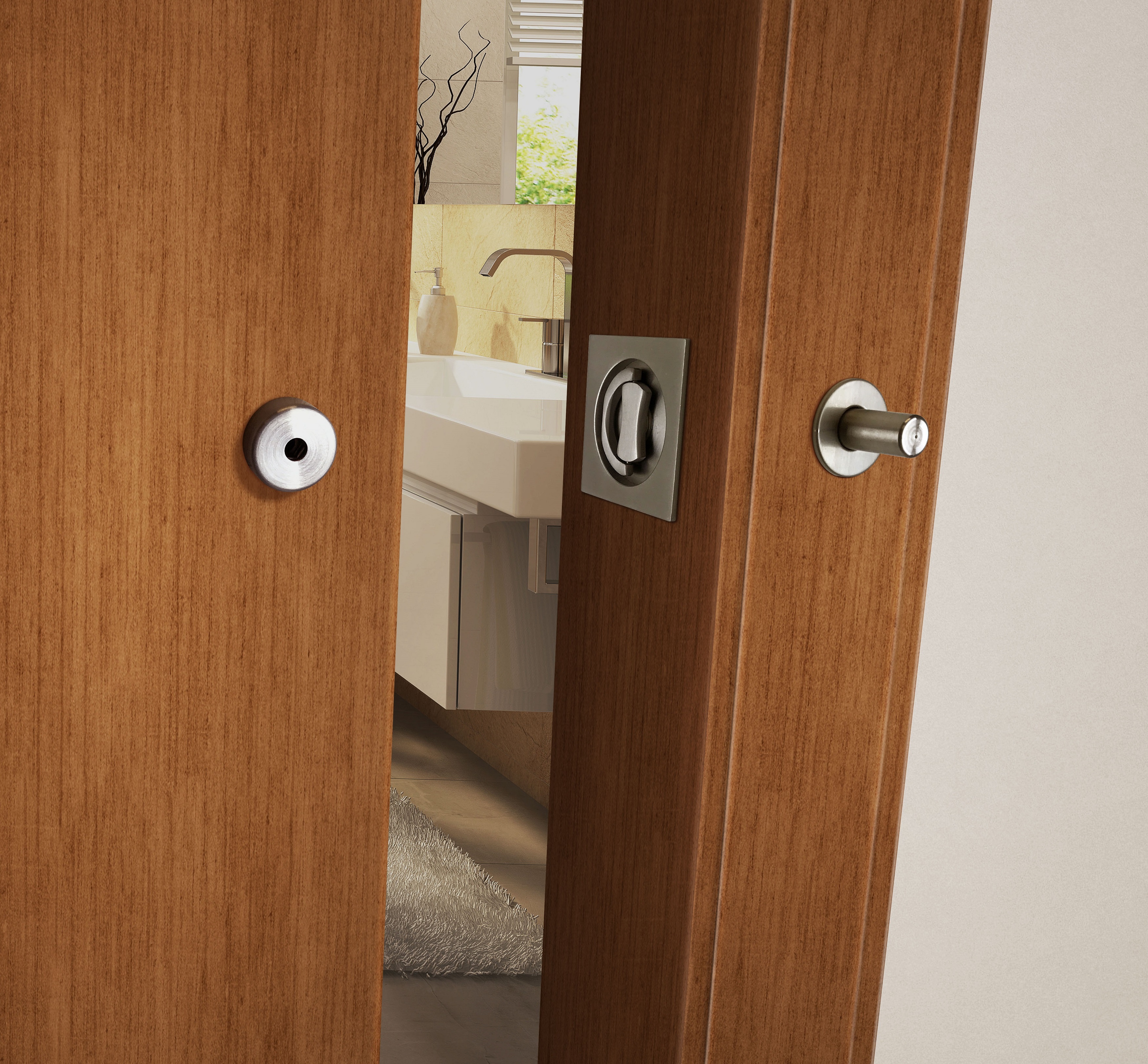 The INOX Barn Door Lock provides an easy-to-use thumb turn (with ADA options) that allows the barn door to be locked securely from inside the room. Shown in Satin Stainless Steel.