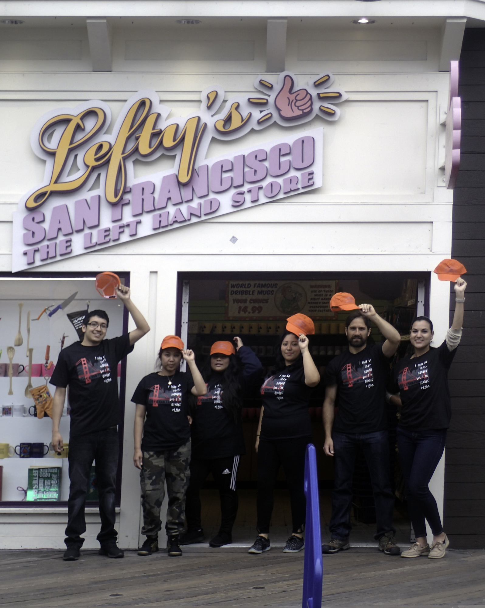 Left-handed employees at Lefty's with Left-Handers' Day Hats