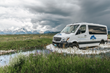 Traveling comfortably in Mercedes-Benz Sprinter custom safari vehicles, Wildlife Expeditions guests explore Yellowstone in style, popping open the roof hatch for spectacular views (photo by Orijin Med
