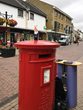 Gnome UK photographed on top of an English postbox in Bicester, England by his volunteer travel companion Alison.
