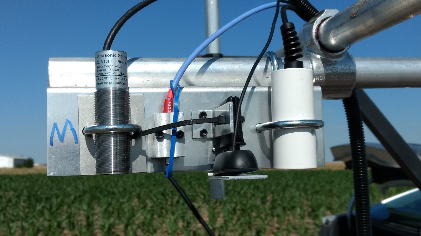 The Senix ToughSonic 14 on the left, pointed down at the crop canopy along with other sensors.