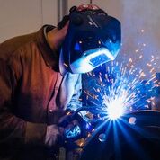 SMW apprenticeship training center student welding sheet metal for HVAC system.