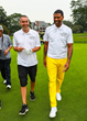 Jalen Rose and David Jacoby walk to the green at The Jalen Rose Golf Classic at Detroit Golf Club