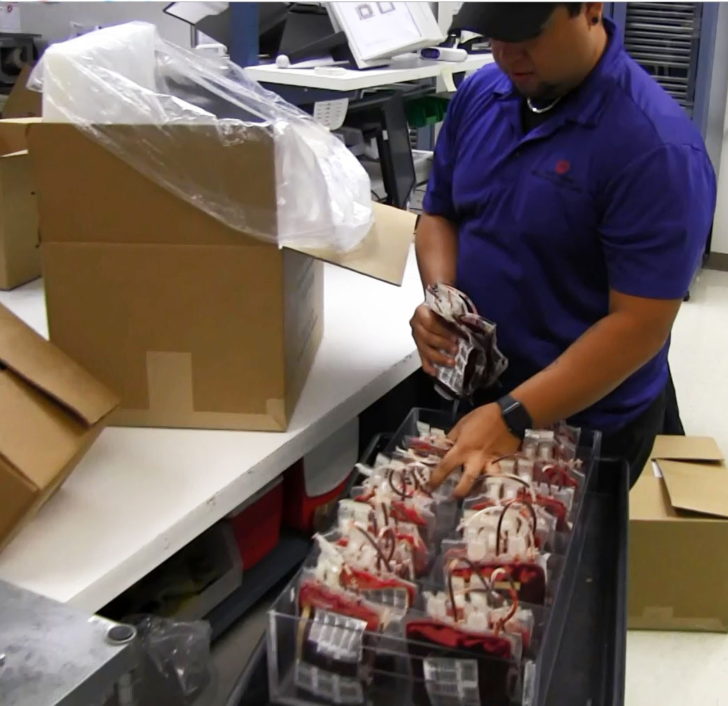 Hospital Services employee Joey Abascal  prepares a shipment of red blood cells from the South Texas Blood & Tissue Center.