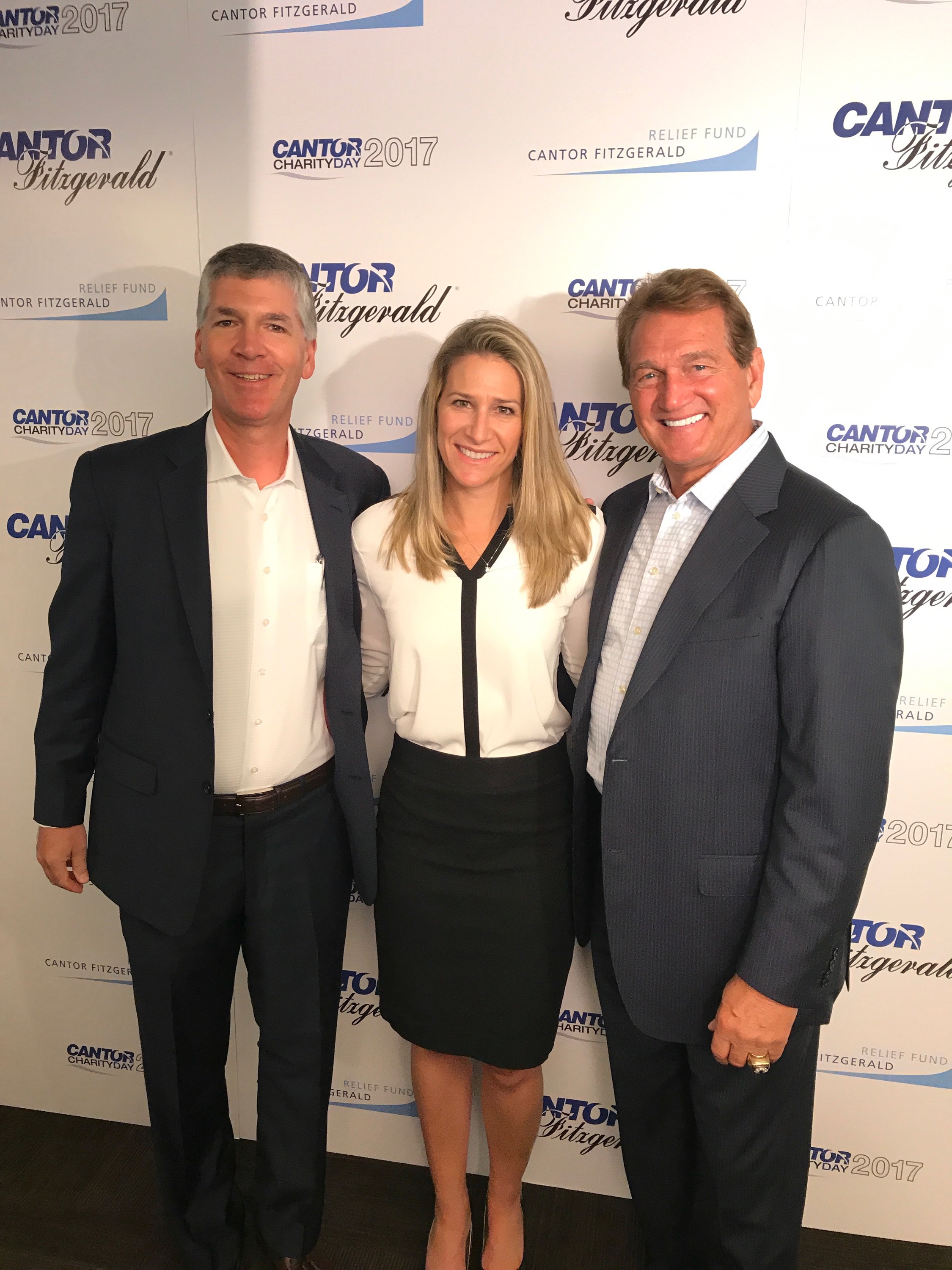 (L to R) Shelters to Shutters' CEO Andy Helmer and Dir of Marketing Kristen Fagley, join Joe Theismann, NFL great as he represents Shelters to Shutters at Cantor Fitzgerald Charity Day 2017.