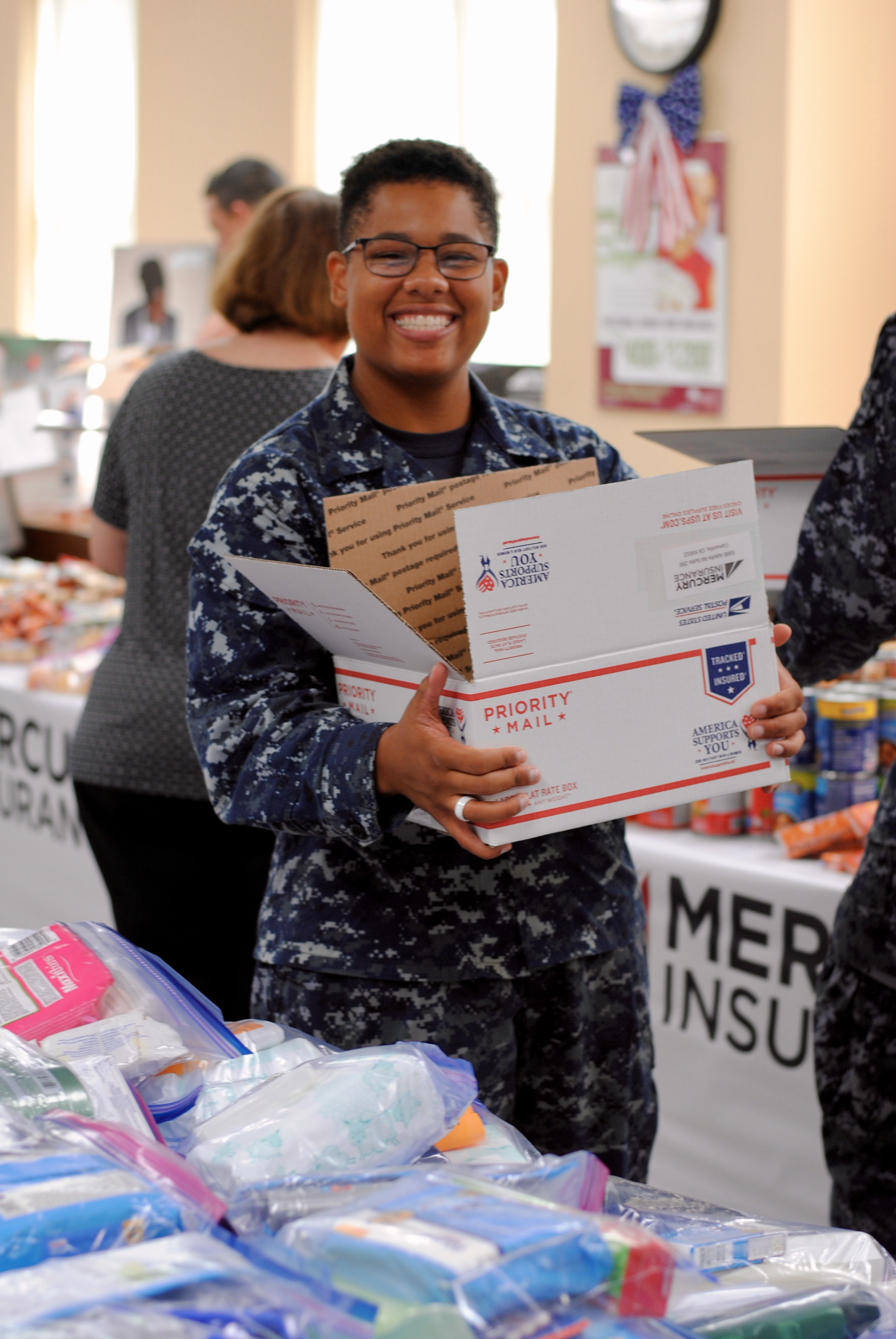 Active-duty soldiers help at the Mercury Insurance packing party.