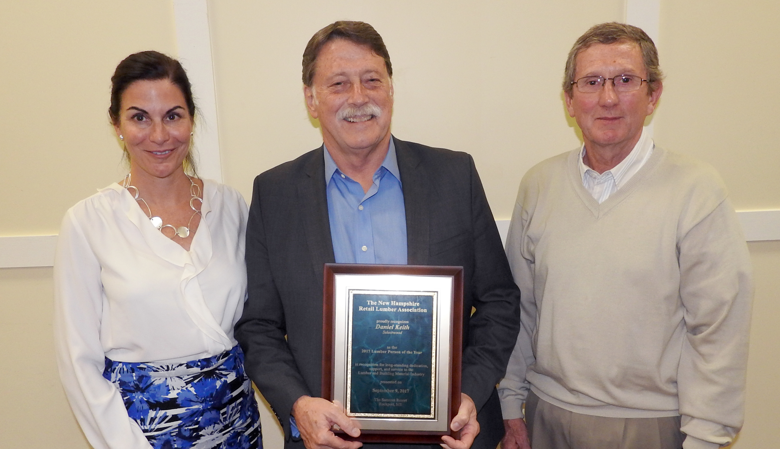 Dan Keith (center) receives his 2017 Lumber Person of the Year award from NRLA President Rita Ferris, and NRLA Chair Bob Bicknell