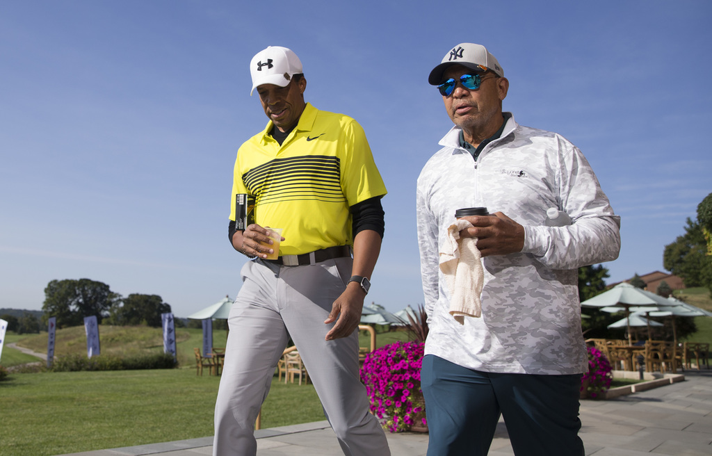 Tony Cornelius (L) and Reggie Jackson (R) prepare to tee-off at The 2017 Julius Erving Golf Classic