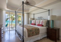 Master bedrooms with king beds have a view of Grace Bay.