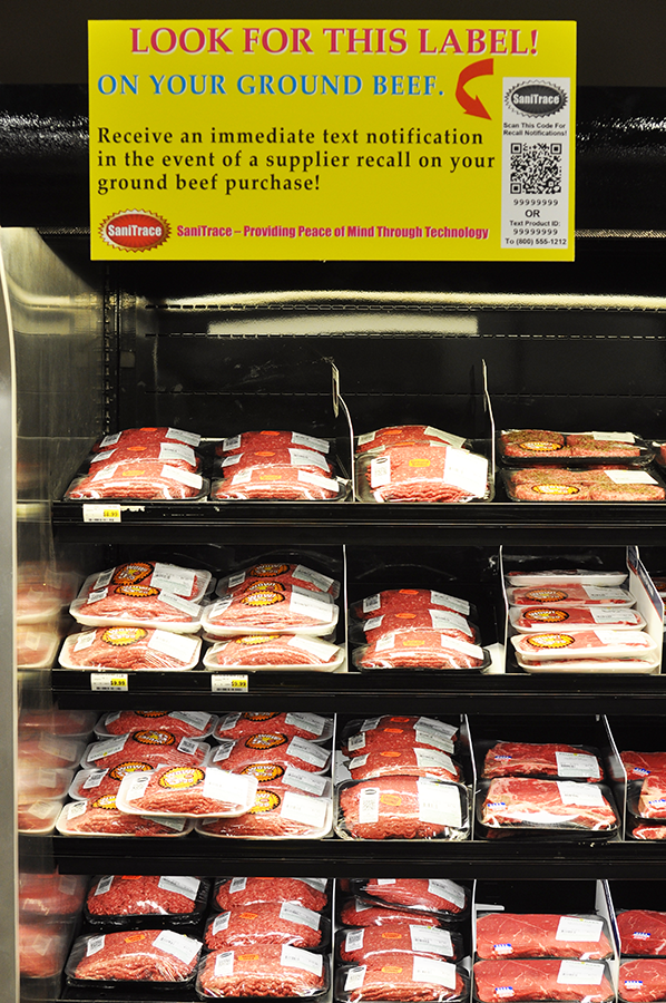A grocery store meat case full of SaniTrace labeled prewrapped packages of ground beef.